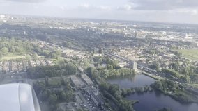 airplane window, aerial view, takeoff, Rotterdam, Netherlands, airplane engine, travel footage, aircraft wing, aviation, urban landscape, cityscape, Dutch city, summer sky, fluffy clouds, travel vibes - Powered by Shutterstock - Get 15% off with code: PIKWIZARD15
