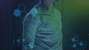 Man standing in dark tech space, code and DNA helix settling, reaching to place VR headset. Futuristic, innovation, neuroscience, immersive, cybernetics, virtual, digital - Powered by Shutterstock - Get 15% off with code: PIKWIZARD15