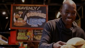 Male bakery vendor smiling and reaching for roll with tongs as animated bars pulsing serving client. Bakery, artisan, storefront, confectionery, retail, craftsmanship, vibrant - Powered by Shutterstock - Get 15% off with code: PIKWIZARD15