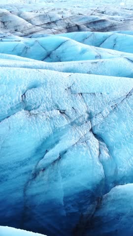 Vertical Screen: Vatnajokull Glacier in Iceland. Pure blue ice, winter landscape aerial view 4k. Largest glacier in Europe. Popular tourist attraction, melting glacier. Shot for Social Media