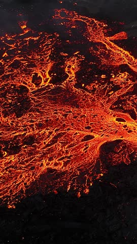 Vertical Screen: Volcano eruption in 2023, Red burning lava erupts from the ground in Iceland. Formation of a new active volcano. Aerial footage. Shot for Social Media.