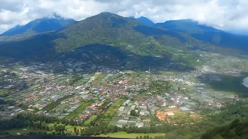 View of houses, tree and some buildings seen from above. Video from above in the form of houses, trees, clouds and hills