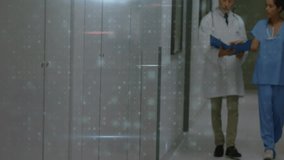 Doctor and nurse walking hospital hall while grid overlay showing malware detection numbers pulsing. Medical, technology, cybersecurity, digital, healthcare, data, analysis - Powered by Shutterstock - Get 15% off with code: PIKWIZARD15