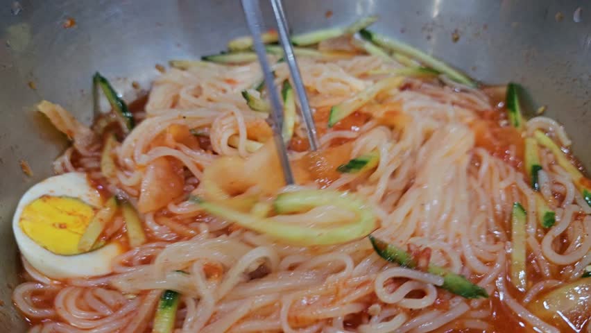 A scene of a bowl of Milmyeon, a popular noodle dish in Korea during the summer