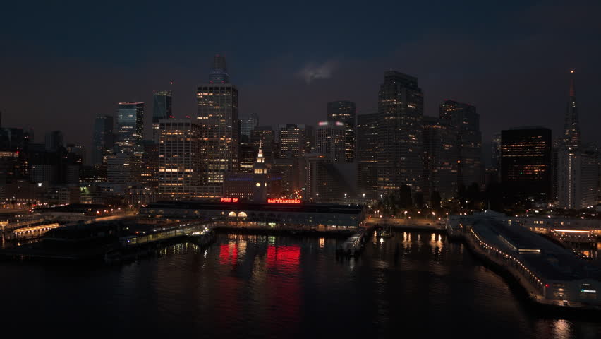 Stunning aerial view of San Francisco, beautiful at night, remarkable city skyline, illuminated buildings and enchanting fog hovering over the bay with full moon, San Francisco, California, USA