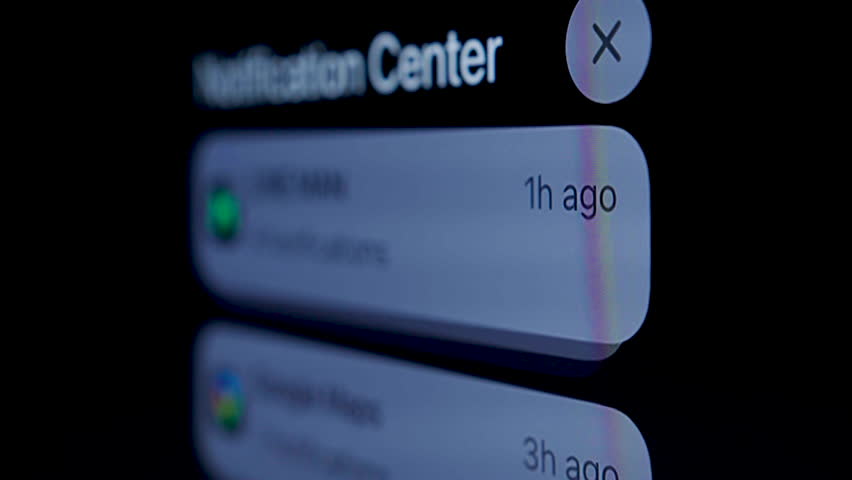 Close-up, Black mobile phone screen shows various notifications.