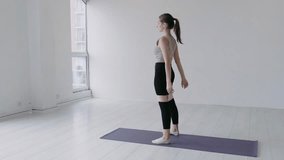 Attractive happy caucasian girl in sportswear doing squats with a fitness elastic band on her legs. Concept of sporty female in a studio, Limbering-Up exercises. Slow-motion cinematic shot - Powered by Shutterstock - Get 15% off with code: PIKWIZARD15