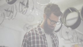 shop employee glancing at tablet in shop, tapping and growing network overlay on wheels and frames. Technology, connectivity, innovation, digital, industry, urban, modern - Powered by Shutterstock - Get 15% off with code: PIKWIZARD15