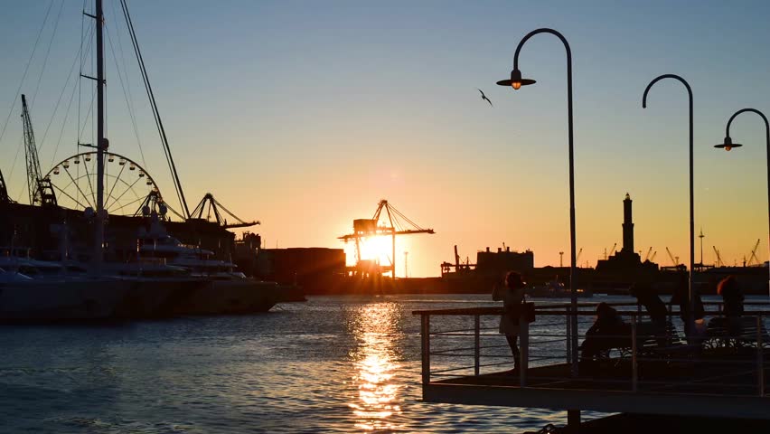 Port of Genoa with the iconic Lanterna at sunset from the "Isola delle chiatte"