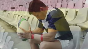 Sports scene capturing rugby player sitting on stands focusing by clasping ball and scanning field. Athlete, concentration, focus, determination, solitude, stamina, athleticism - Powered by Shutterstock - Get 15% off with code: PIKWIZARD15