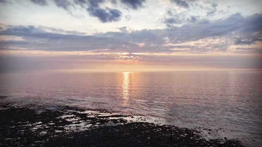 A drone hyperlapse of sunset on the sea at Aberaeron in Wales