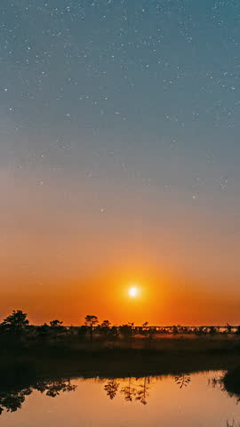 Braslaw District, Vitebsk Voblast, Belarus. Real Colorful Night Stars Above Braslav Braslau Lake. Natural Starry Sky Landscape Time lapse Time-lapse. Sky Reflection In Water.