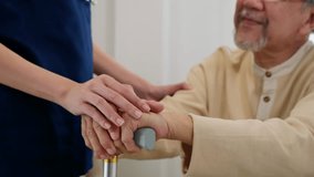 Close up hands of doctor or nurse assisting holding hand of old man patient on cane or walking stick during a medical checkup, doctor palm covering hand of senior, Health care and medical elderly care - Powered by Shutterstock - Get 15% off with code: PIKWIZARD15