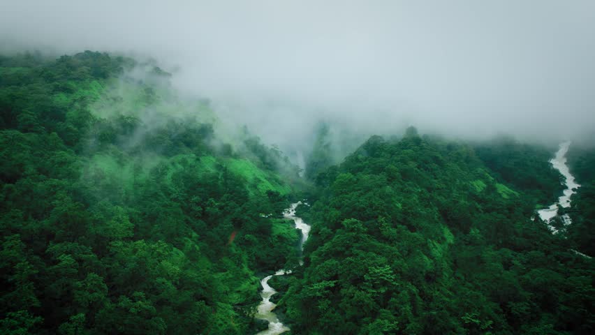 4K Aerial shot of Kalu waterfall covered in rain clouds during monsoon season at Maharashtra, India. Nature landscape. travel, holidays, vacation, trekking and adventure concept. 