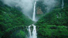 4K Aerial shot of mesmerising Nanemachi waterfall falling from cliff in Sahyadri hills during monsoon season at Maharashtra, India. Drone view of powerful waterfall in lush green forest landscape.  - Powered by Shutterstock - Get 15% off with code: PIKWIZARD15