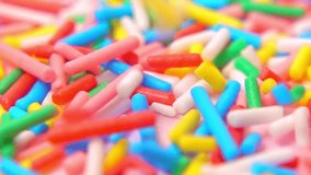 Bright, multihued sprinkles slowly descend on pink backdrop, inviting viewers into world of joy and celebration in every frame, slow motion, macro - Powered by Shutterstock - Get 15% off with code: PIKWIZARD15