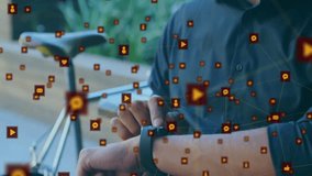 Man tapping smartwatch beside bicycle and tracking social media engagement with floating icons. Digital, connection, technology, outdoor, modern, communication, urban - Powered by Shutterstock - Get 15% off with code: PIKWIZARD15