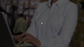 Warehouse specialist typing at laptop forming cart and graph icons network for logistics analytics. Technology, data, connectivity, automation, supply chain, digital, industrial - Powered by Shutterstock - Get 15% off with code: PIKWIZARD15