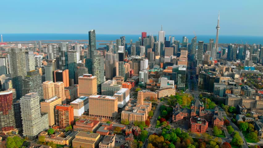 Toronto skyline revealing cn tower and university of toronto campus under bright sunny sky, showcasing urban architectural landscape and metropolitan vibrancy. Urban style concept Canada