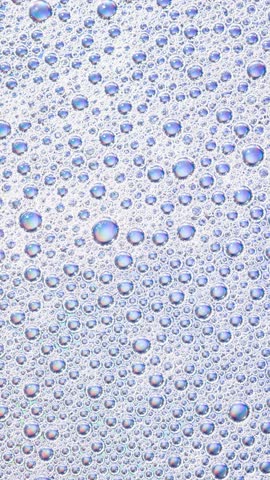 Foam background. Liquid soap bubbles, Froth bubbles backdrop. Soap foam popping bubble rotating, white backdrop. Soap sud macro structure close-up. Clean, cleaning, washing, laundry