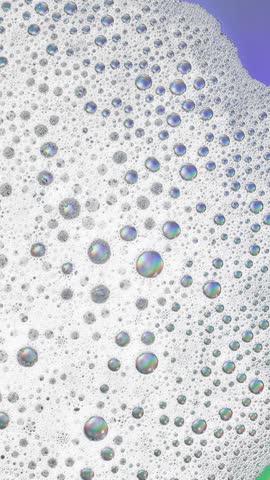 Foam background. Liquid soap bubbles, Froth bubbles backdrop. Soap foam popping bubble rotating, white backdrop. Soap sud macro structure close-up. Clean, cleaning, washing, laundry