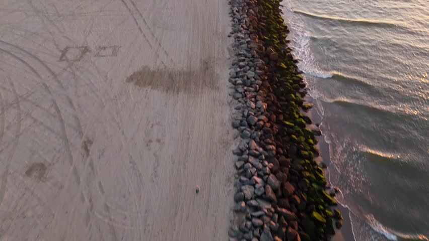 Aerial reveal of Seal Beach, California at sunset with San Gabriel River connecting with the Pacific Ocean