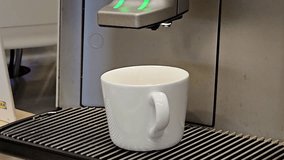 Selfservice coffee machine with coffee droplets and stains pouring espresso and milk for cappuccino into a white ceramic cup
 - Powered by Shutterstock - Get 15% off with code: PIKWIZARD15
