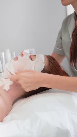 Professional skincare treatment is taking place in a calm spa environment. A client enjoys a soothing facial mask, enhancing their skincare routine and overall relaxation.
