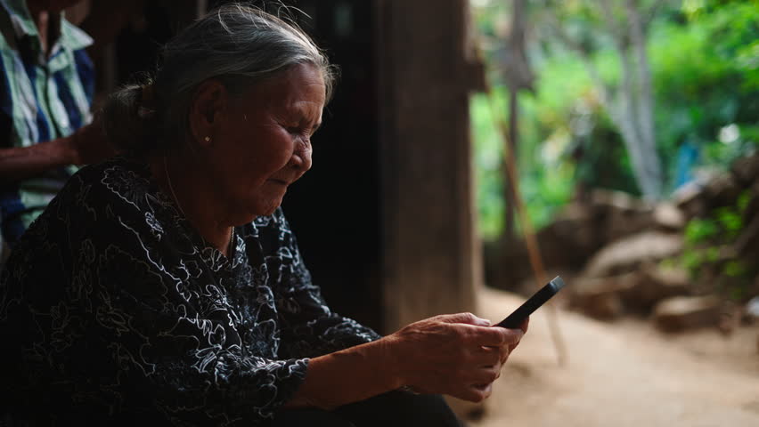 Grandma enjoying new technologies surfing the internet or sending messages to family