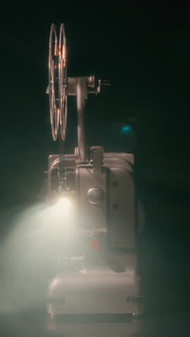 A vintage film projector casts a bright light beam through its lens, with atmospheric smoke in the air, creating a nostalgic cinematic ambiance