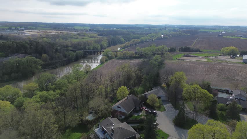 4K Aerial Flyover of a River and Bridge in St. Jacobs, Ontario, Canada
