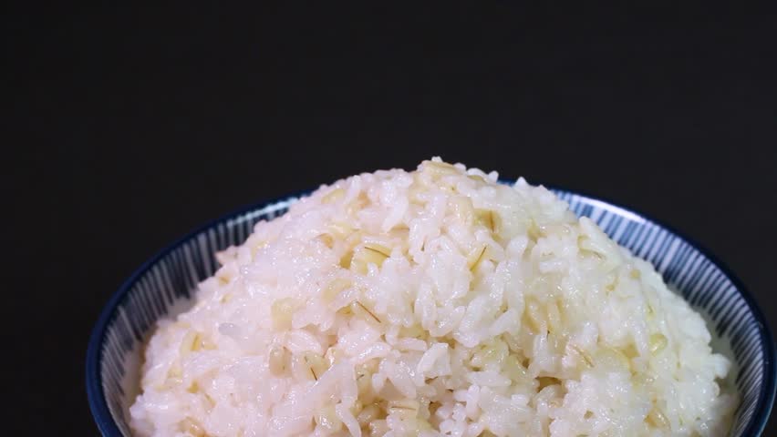 Mugi meshi - japanese glutinous barley rice served in a bowl, rotating