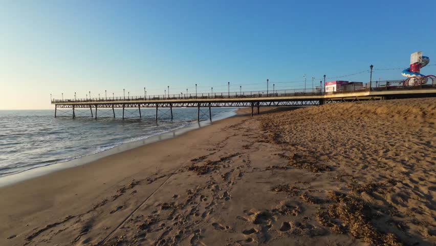 4K | Seaside town of Skegness east coast of the UK. Walk under pier. Early morning, sunrise, sound of waves