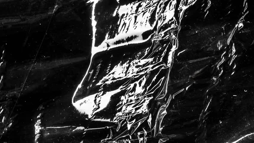 Abstract black and white background with crumpled plastic wrap texture. Modern, minimalist design with light reflections and dark shadows.