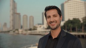 Portrait of confident Latin American businessman in suit smiles to camera on yacht deck. Happy Hispanic man enjoys relaxing trip on modern motorboat against downtown skyscrapers - Powered by Shutterstock - Get 15% off with code: PIKWIZARD15