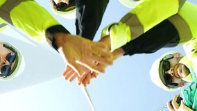Renewable Energy Team collaborating on a wind turbine project. Engineer and technician showing teamwork, ready to develop clean energy at the construction site. - Powered by Shutterstock - Get 15% off with code: PIKWIZARD15