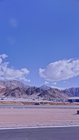 View from the plane window at Ladakh airport. The landscape of Ladakh, nestled in the Himalayas, is lush with rivers flowing from glaciers that feed the parched city. Ladakh city near the airport