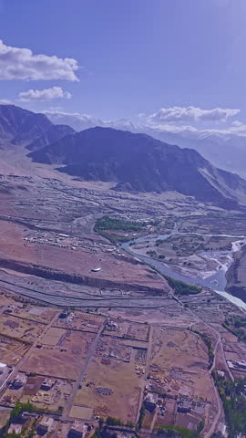 View from the plane window at Ladakh airport. The landscape of Ladakh, nestled in the Himalayas, is lush with rivers flowing from glaciers that feed the parched city. Ladakh city near the airport