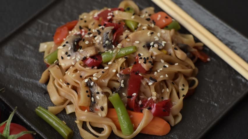 Chinese or Thai food, rice noodles with meat, salt and spices. Asian food as a background