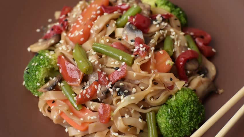 Chinese or Thai food, rice noodles with meat, salt and spices. Asian food as a background