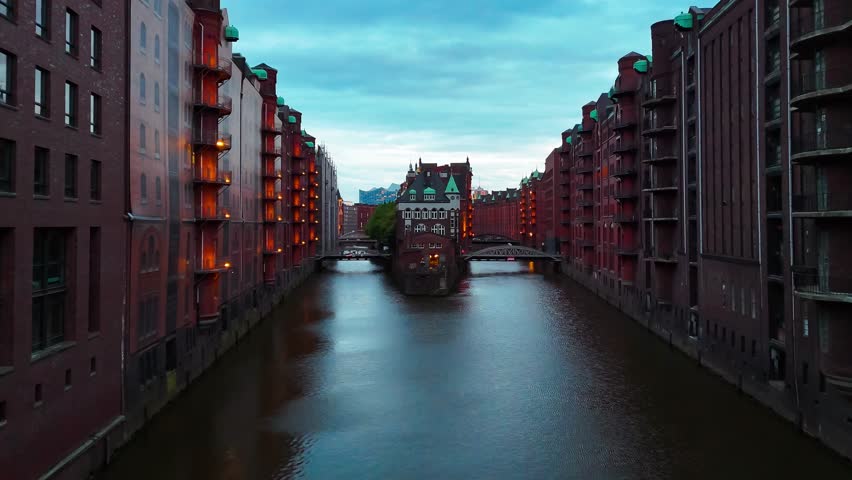 Aerial drone sunset view of bridge, canal and houses the Speicherstadt, Hamburg, Germany, May 19, 2025. High quality 4k footage