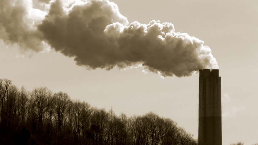 Smoke emerges from a tall stack on an early morning.