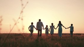 Parents mother father kids playing enjoying nature. Mom dad children daughter son running together on meadow holding hands, sunset. Family with children having fun in summer sunny park. Slow motion - Powered by Shutterstock - Get 15% off with code: PIKWIZARD15