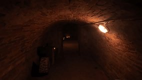 Walking through old cellars. Walk through an old underground corridor lit by candles. The concept of mystery and fear - Powered by Shutterstock - Get 15% off with code: PIKWIZARD15