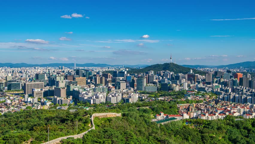 4K Timelapse zoom in. High angle view of Inwangsan Mountain during a clear day with beautiful moving clouds. Seoul, South Korea. August 30, 2024.