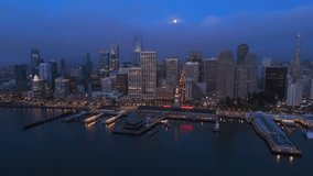 Breathtaking Aerial view of San Francisco stunning skyline at night with full moon, lights twinkling against the bay backdrop, all enveloped in a light fog that enhances the atmosphere. California - Powered by Shutterstock - Get 15% off with code: PIKWIZARD15