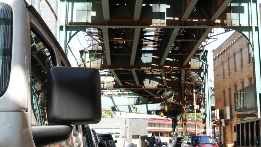 Elevated subway above New York city street. Metropolitan bridge over road, Queens. Long Island overhead metro line, Court Square, United States. Cars and diner under vintage railway track. Urban life.