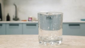 Fresh orange juice cascading into clear glass, highlighting vibrant citrus color and nutritional value while capturing dynamic pouring moment on rustic kitchen table surface - Powered by Shutterstock - Get 15% off with code: PIKWIZARD15