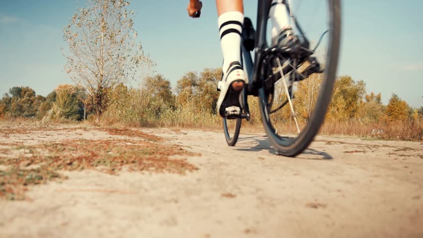 Cyclist Riding On Gravel Bike In Slow Motion. Cyclist Athlete Workout Riding On Gravel Bicycle. Gravel Bike Cyclist Exercise On Trail Road Enhance Skills. Cardio Gravel Cycling Trail Cross