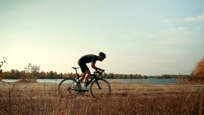 Cyclist Riding On Gravel Bike In Slow Motion. Cyclist Athlete Workout Riding On Gravel Bicycle. Gravel Bike Cyclist Exercise On Trail Road Enhance Skills. Cardio Gravel Cycling Trail Cross